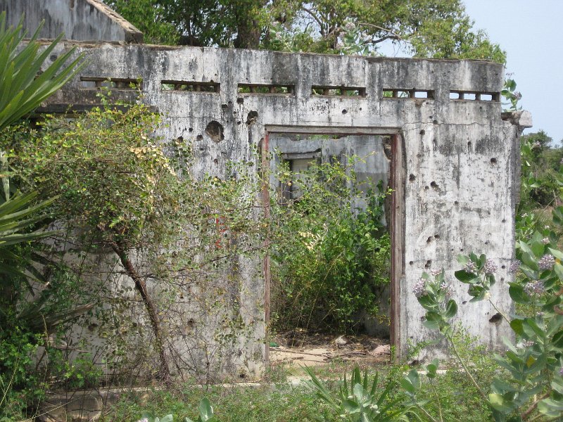 House showing damage from bullets and shells